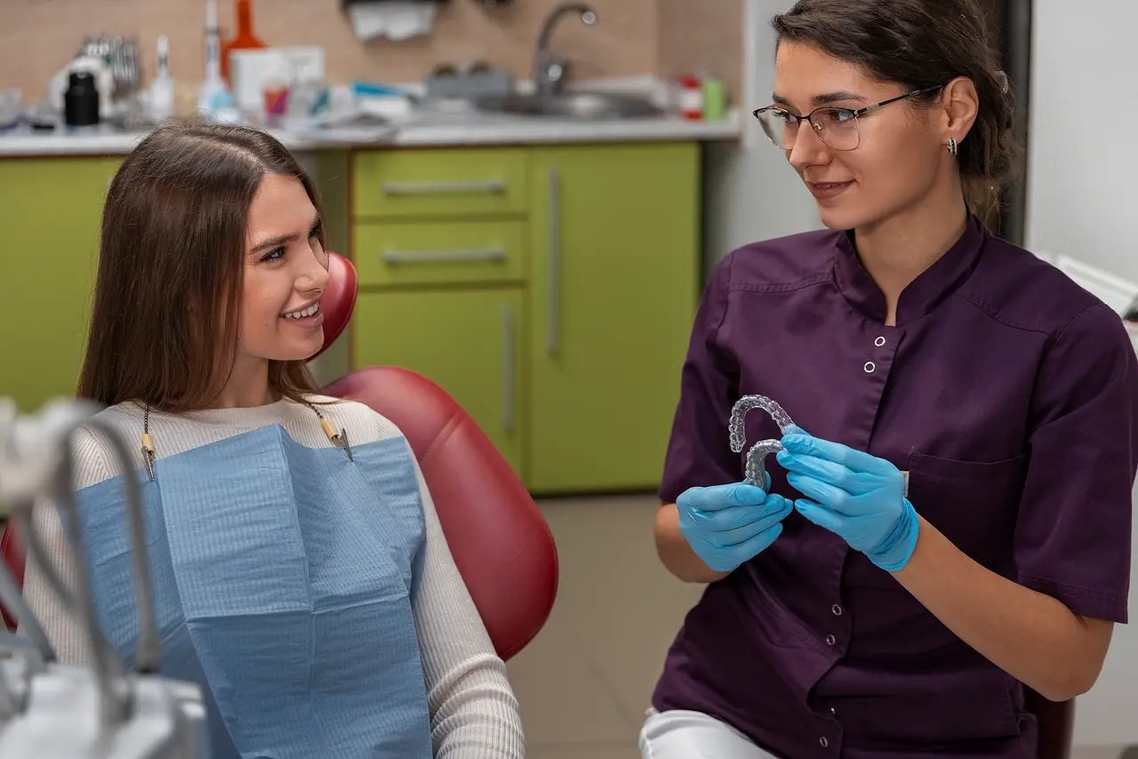 Vivos sleep apnea consultation with a dentist Dentist showing a custom oral appliance to a patient during a Vivos sleep apnea consultation