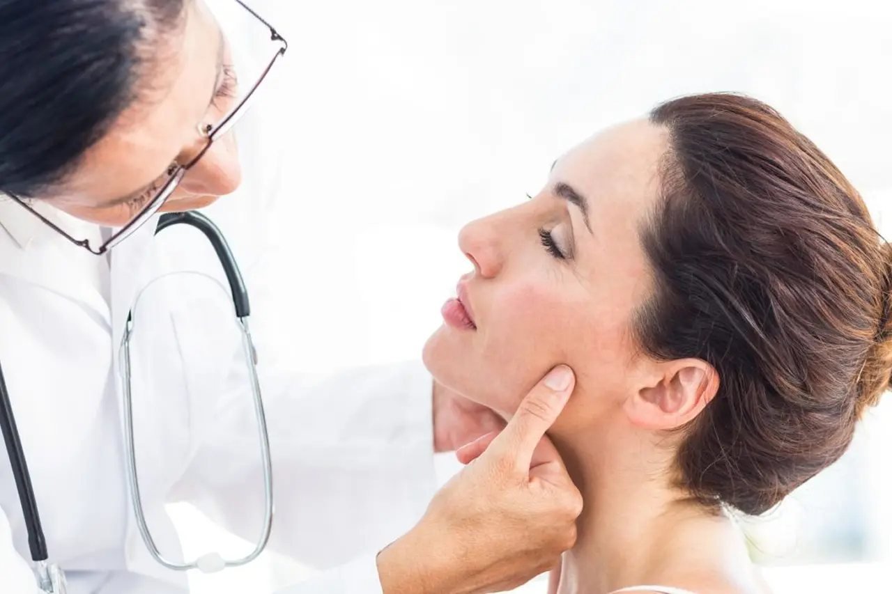 TMJ and airway evaluation with a specialist Doctor examining a patient’s jaw and temporomandibular joint during an airway and facial pain evaluation