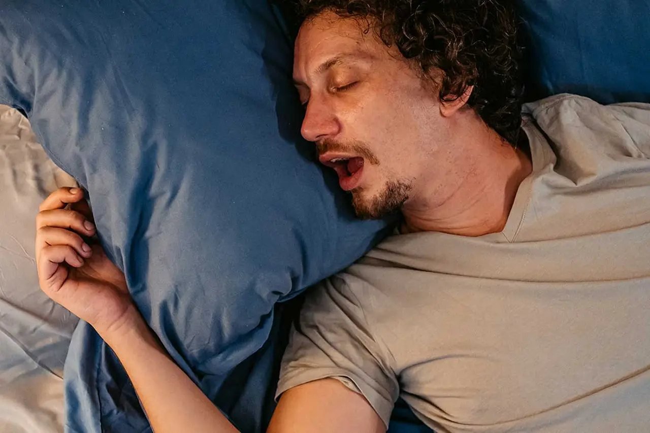 Mouth breathing while sleeping Adult man sleeping with his mouth open, illustrating mouth breathing while sleeping