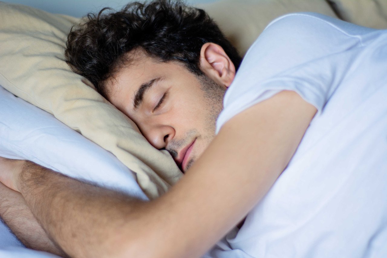 Disrupted night-time breathing and daytime focus Man asleep in bed at night with his mouth slightly open