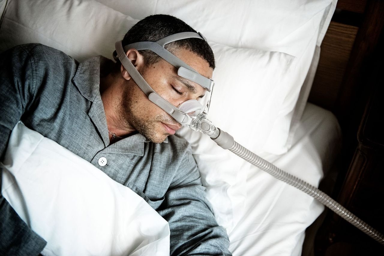 Risk factors point to a conversation, not a diagnosis Man sleeping with a CPAP mask over his nose