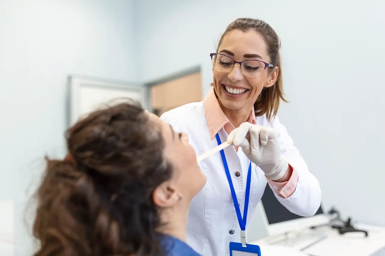 Dental professional performing a thorough oral exam to assess airway health for Vivos treatment
