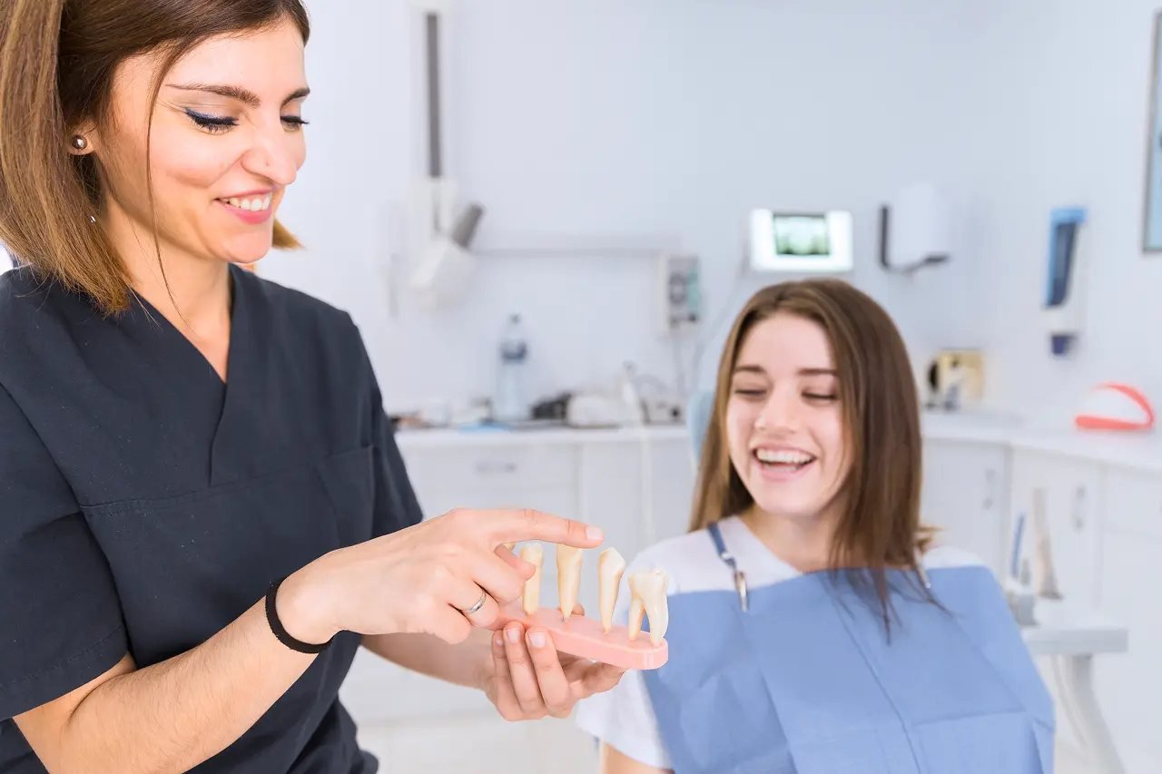 Dental specialist using a dental model to explain how the Vivos DNA appliance treats airway issues